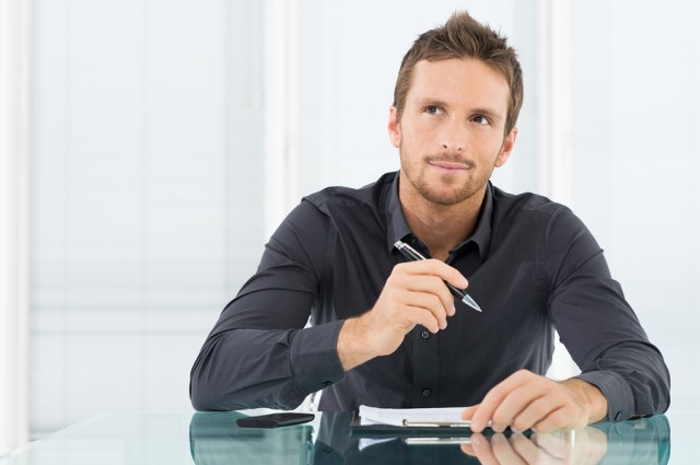 Young Businessman Thinking and Wondering While Writing a Paper Image Source: Writing and PR Studio (BigStock Images)