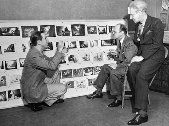 Walt Disney running through a storyboard with colleagues Image source: Kashinterest