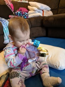 Baby Zoe playing with Tag rag made from reusable breast pad and ribbons Baby Zoe playing with Tag rag made from reusable breast pad and ribbons