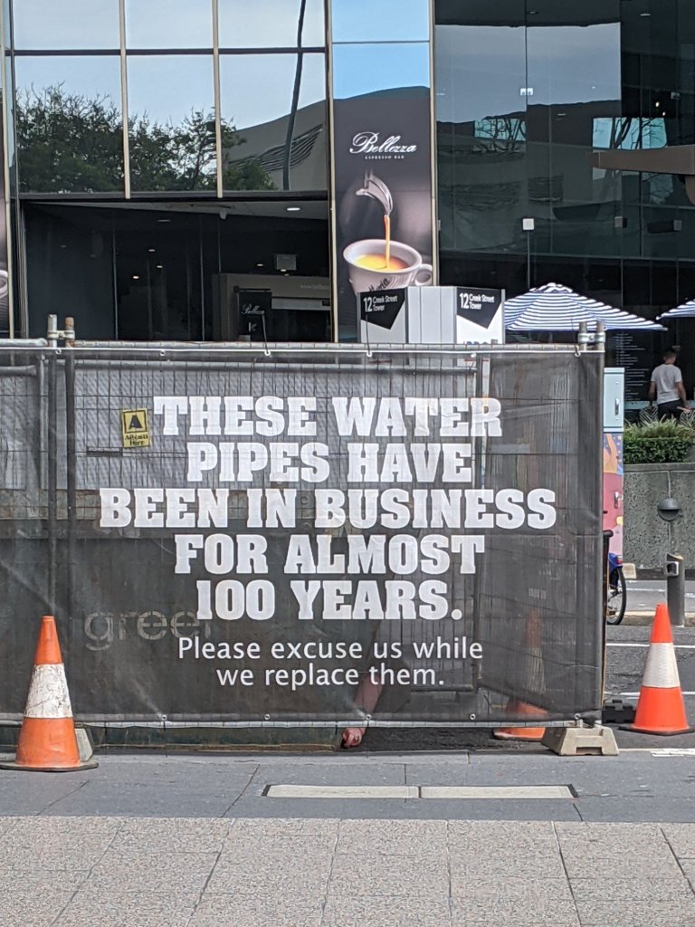 Urban Utilities ad in Brisbane CBD November 2020: These water pipes have been in business for almost 100 years. Please excuse us while we replace them.